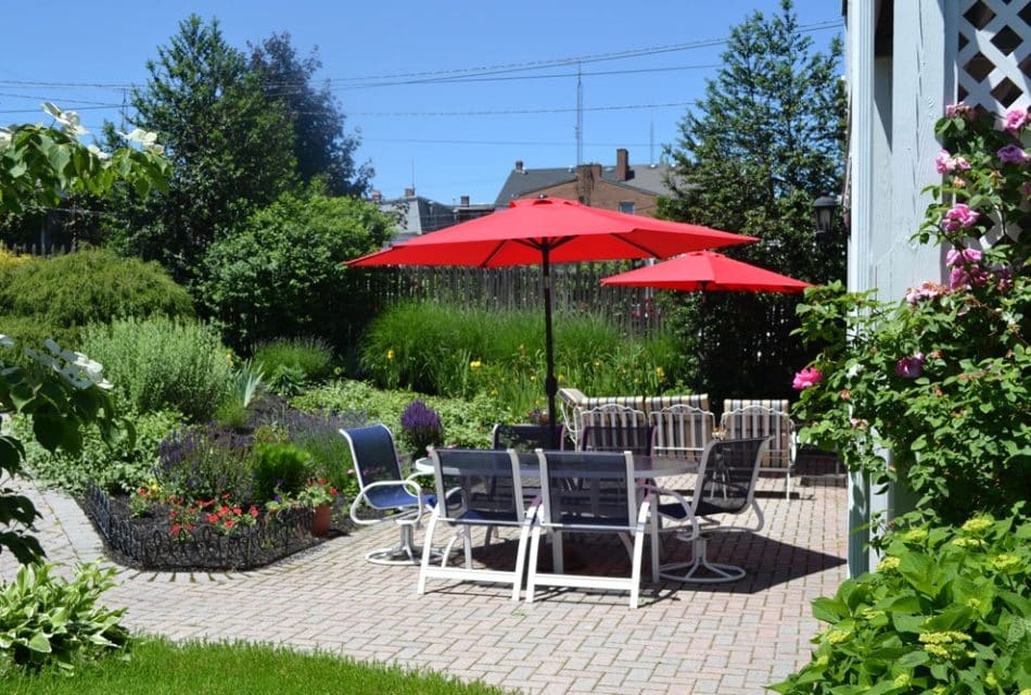 Sunny patio with table and red umbrellas